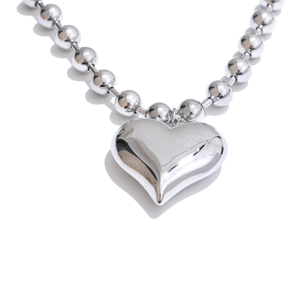 Silver heart-shaped pendant on a beaded chain with size and weight information.