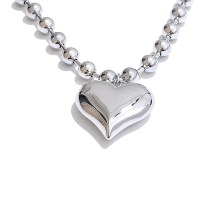 Silver heart-shaped pendant on a beaded chain with size and weight information.
