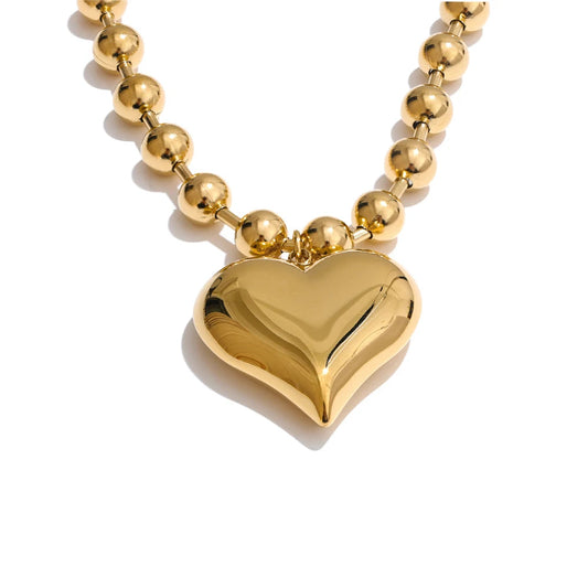 Gold heart-shaped pendant necklace on a white background with 'YaPup' branding.